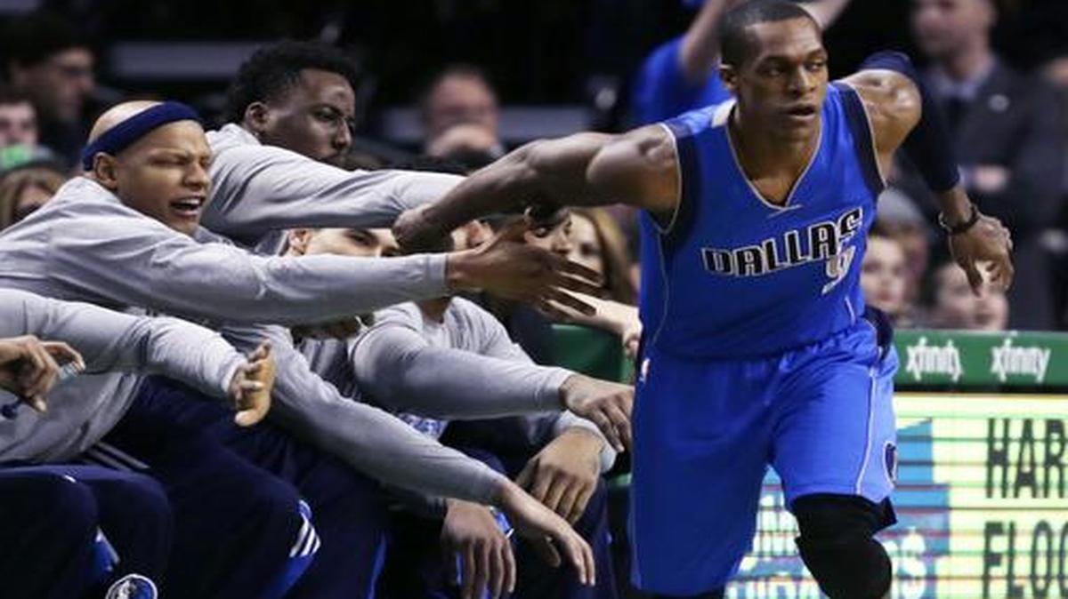 
Dallas Mavericks guard Rajon Rondo  is congratulated by teammates after hitting a 3-pointer in front of the bench during the first quarter against the Boston Celtics on Friday. 
