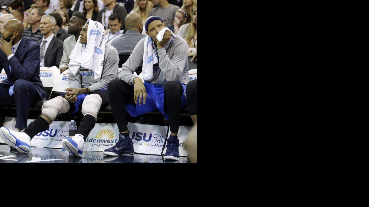 
Dallas Mavericks guard Rajon Rondo, left, and teammate Charlie Villanueva, right, look on while sitting on the bench during the fourth quarter of Monday’s game at the Utah Jazz. 
