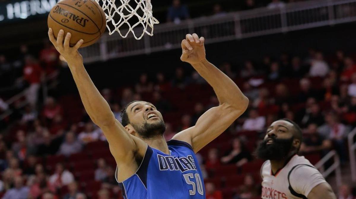 Dallas Mavericks center Salah Mejri (50) scores on a layup as Houston Rockets guard James Harden (13) looks on. Mejri, in his first NBA start, had 10 points, 11 rebounds and three blocked shots.