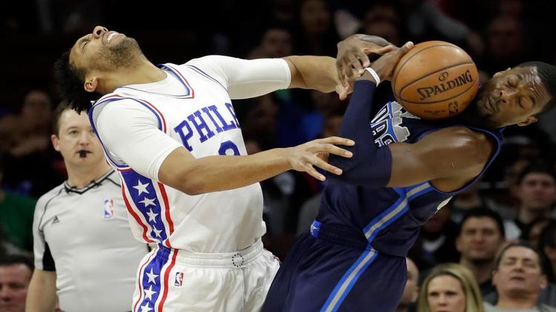 Dallas Mavericks' Harrison Barnes, right, and Philadelphia 76ers' Jahlil Okafor collide after chasing a loose ball during the first half of an NBA basketball game, Friday, March 17, 2017, in Philadelphia.