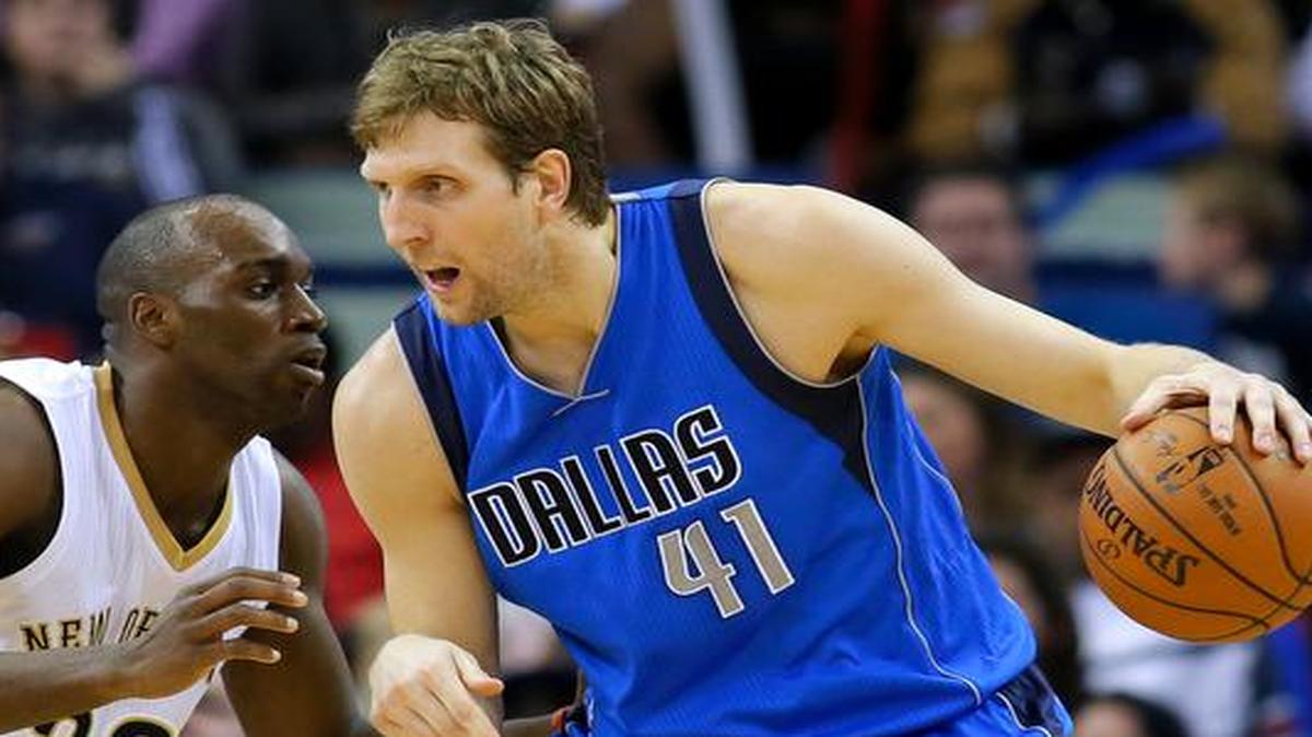 
Dallas Mavericks forward Dirk Nowitzki (41) drives against New Orleans Pelicans guard Quincy Pondexter (20) during the second half of an NBA basketball game, Sunday, Jan. 25, 2015, in New Orleans. 
