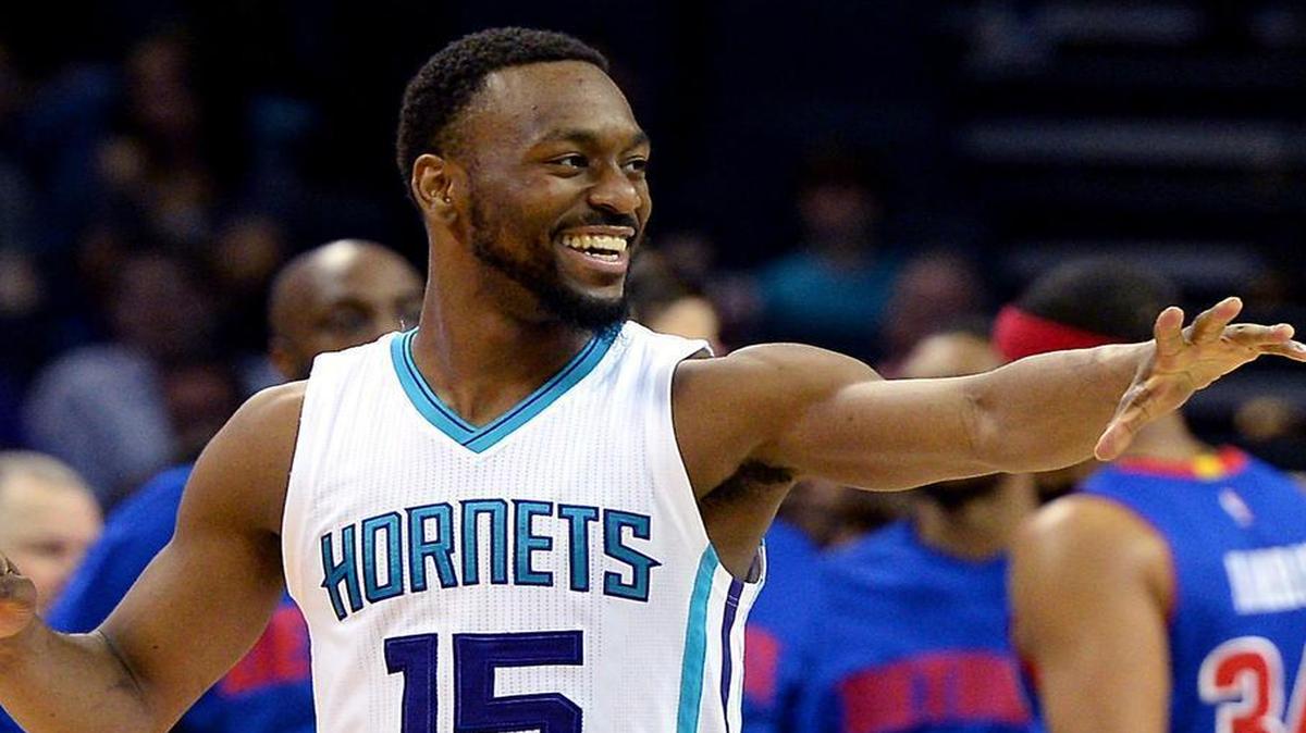 Charlotte Hornets guard Kemba Walker reaches out to congratulate a teammate following a score against the Detroit Pistons on Friday.