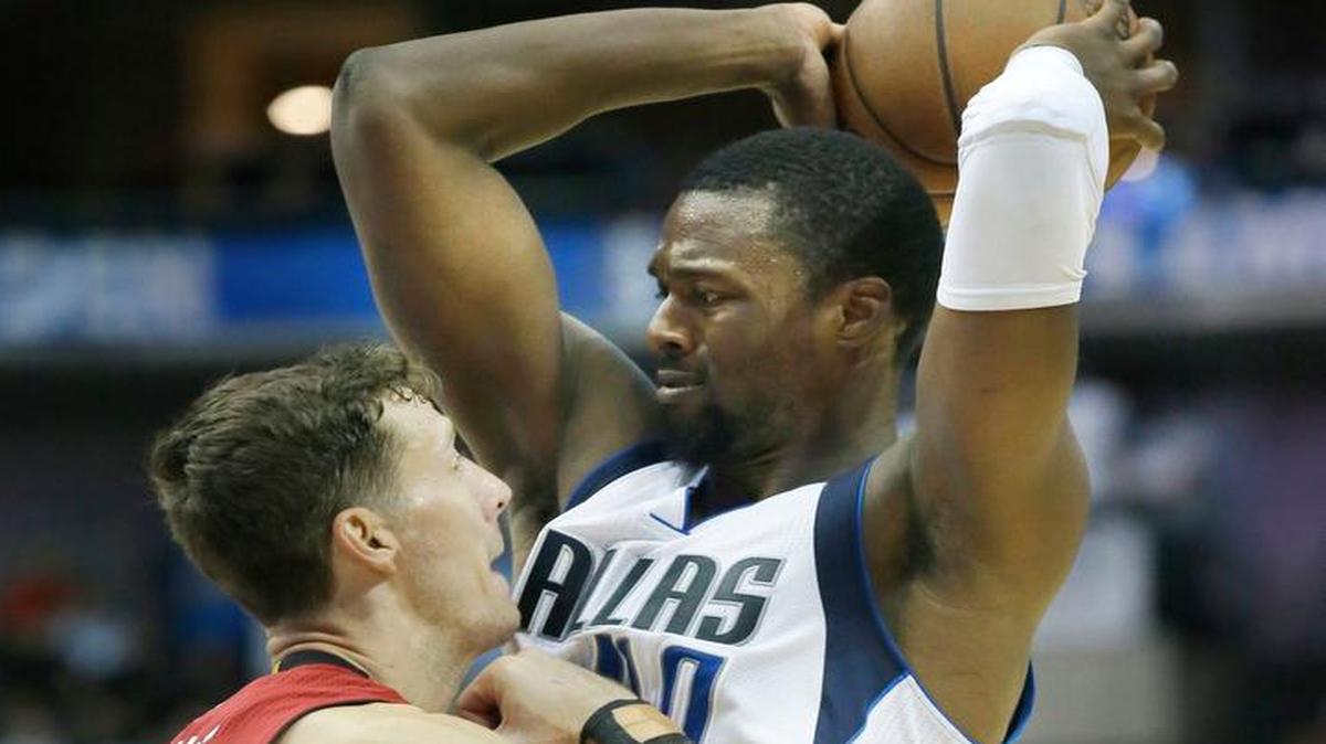 Dallas Mavericks forward Harrison Barnes (40) gets some tight defense from Miami Heat guard Goran Dragic (7) during the second half of an NBA basketball in Dallas, Monday, Feb. 27, 2017. The Mavericks won 96-89.
