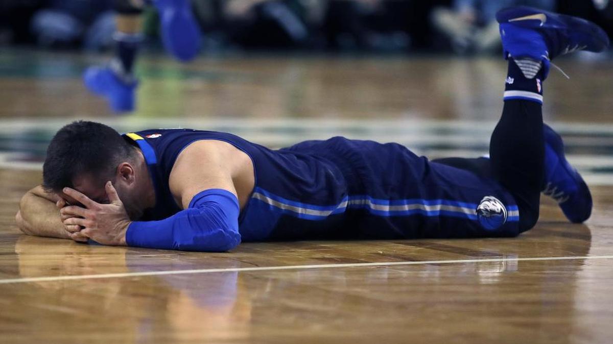 Dallas Mavericks guard J.J. Barea drops to the floor after straining his left calf against Boston. He will not play against Memphis Friday night.