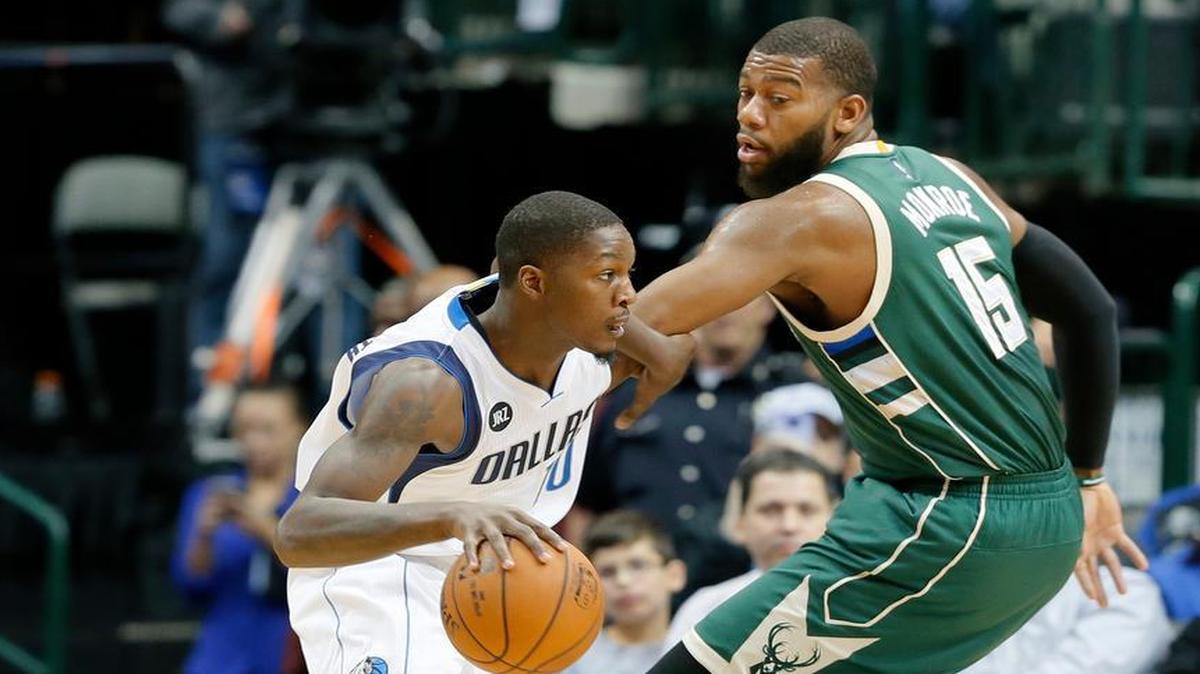 Dallas Mavericks forward Dorian Finney-Smith, left, dribbles past Milwaukee Bucks center Greg Monroe, right at American Airlines Center. Finney-Smith will likely be tasked with guarding New York Knicks forward Carmelo Anthony on Monday.