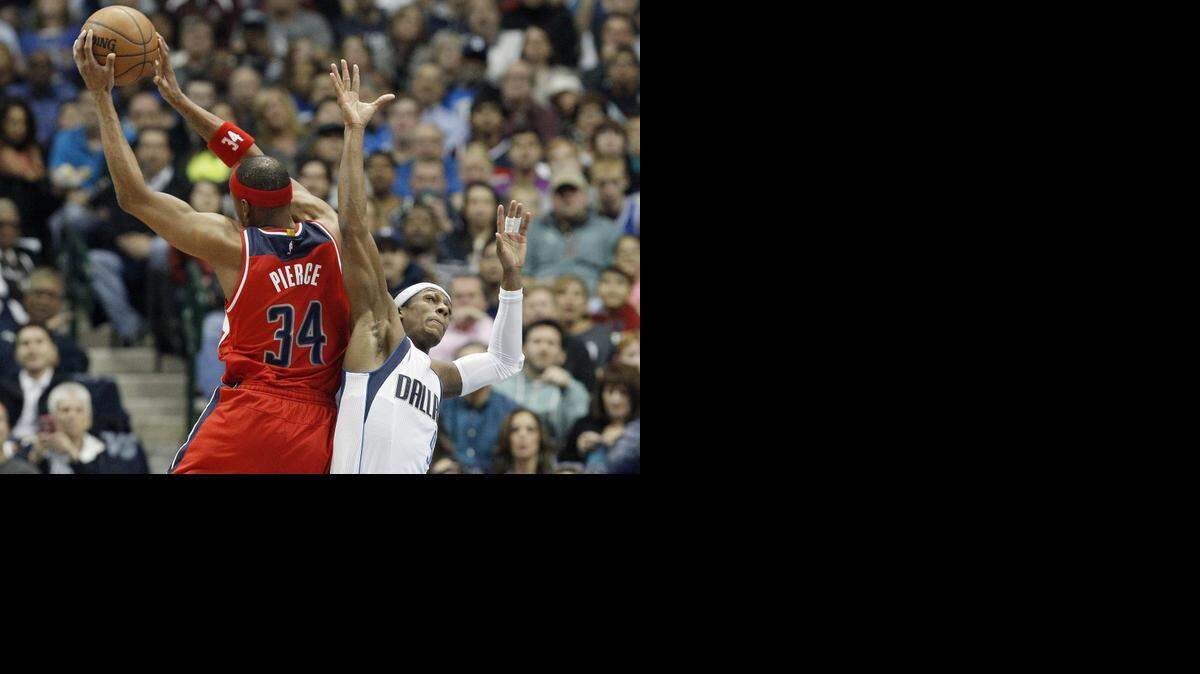 
Wizards forward Paul Pierce, left, beats Mavericks guard Rajon Rondo to a rebound on Tuesday. Washington outrebounded Dallas 48-34 despite the Mavericks’ 114-87 victory.


