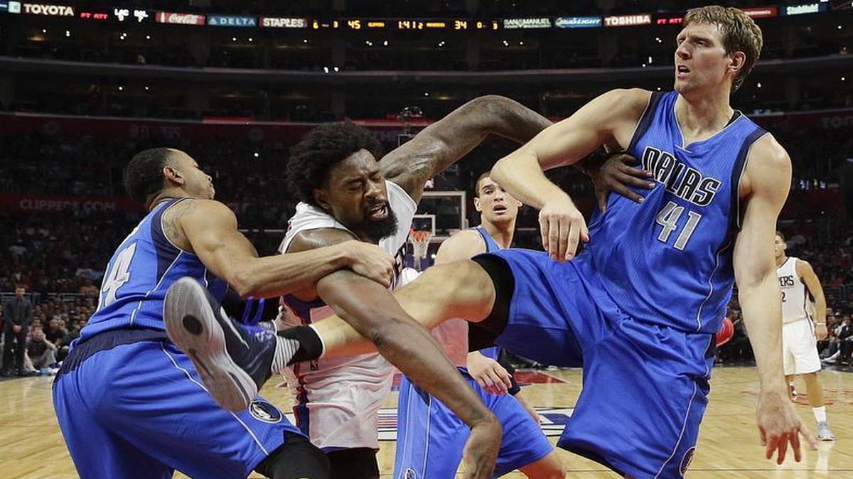 Clippers’ DeAndre Jordan, center, is tangled up with Mavericks’ Dirk Nowitzki, right, and Devin Harris during the first half.