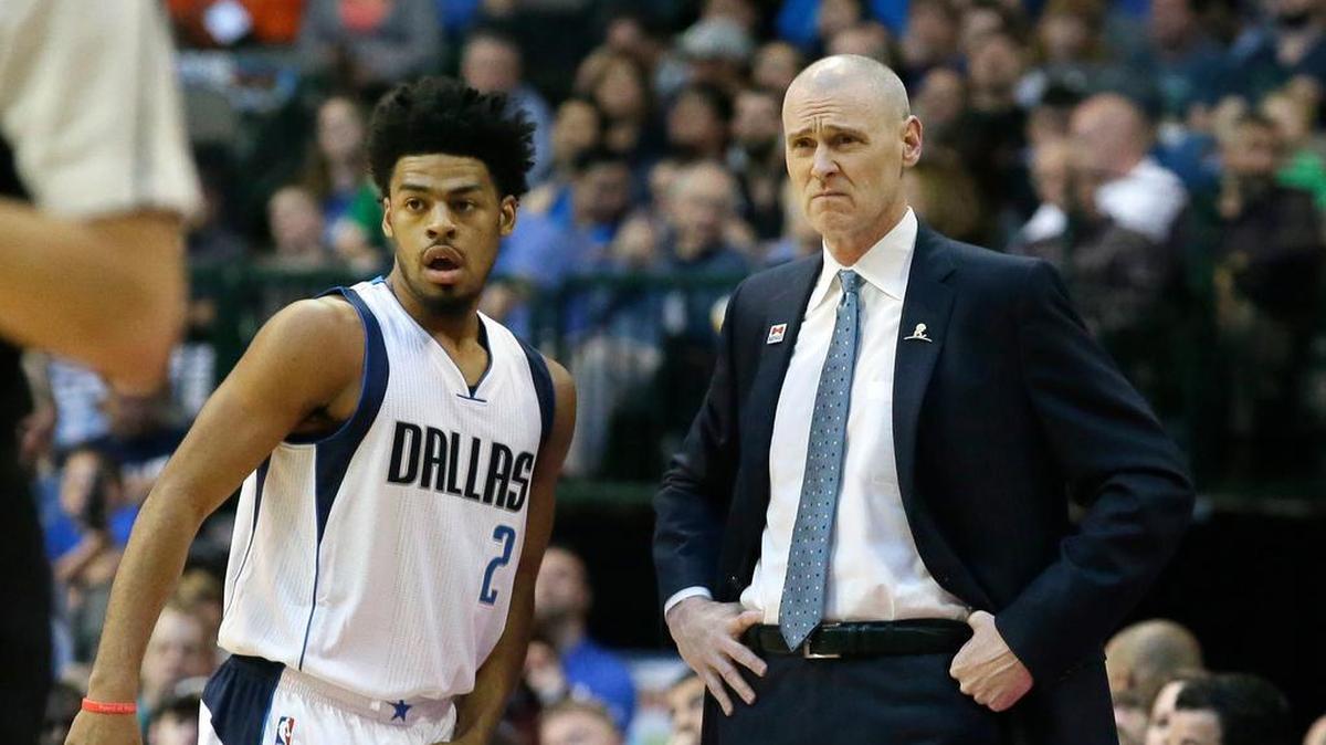 Dallas Mavericks head coach Rick Carlisle and new guard Quinn Cook (2) look on from the sideline during the first half against the Miami Heat in Dallas on Monday.