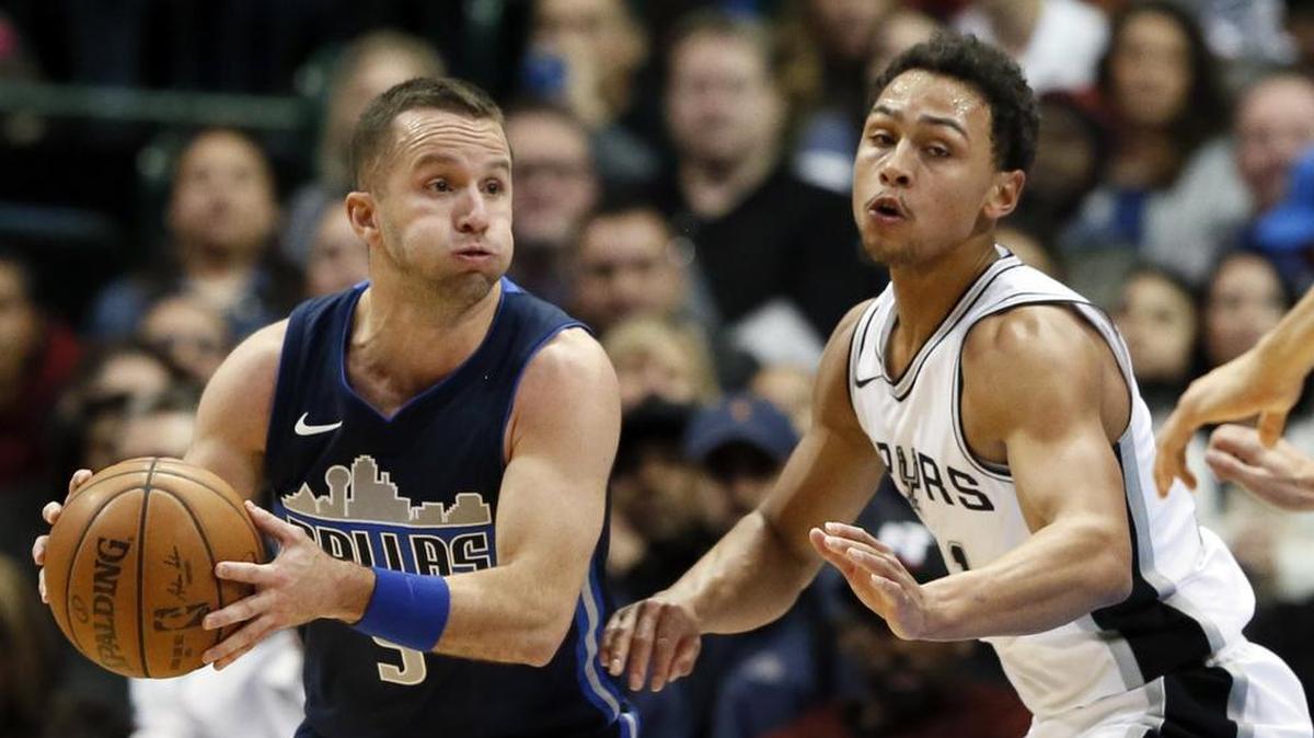Dallas Mavericks guard J.J. Barea (5) looks to make a pass as San Antonio Spur Bryn Forbes (11) defends.