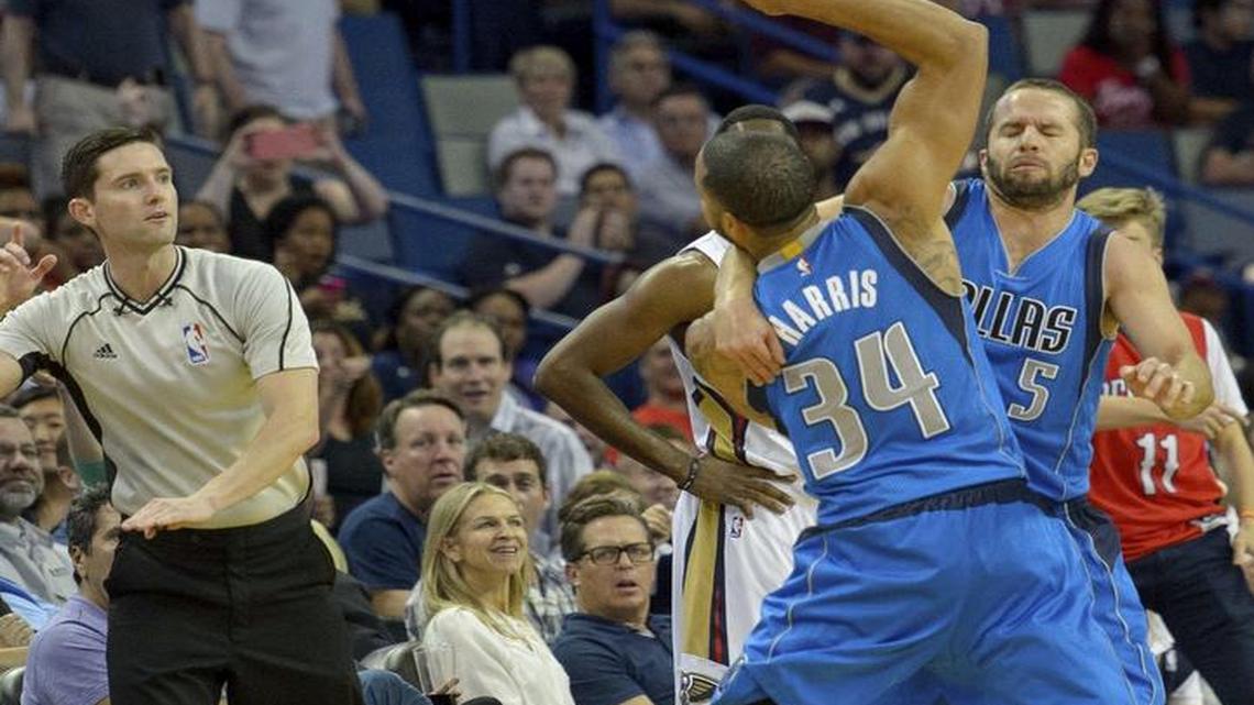 Dallas Mavericks guard Devin Harris (34) charges toward referee Ben Taylor (46) as he is held back by Mavericks guard J.J. Barea (5) in Wednesday’s game in New Orleans.