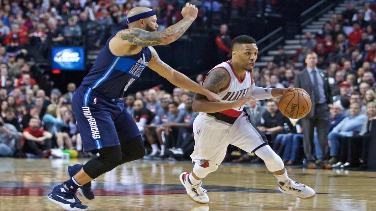 Trail Blazers guard Damian Lillard, right, scored a game-high 27 points lead Portland past Deron Williams and the Dallas Mavericks 109-103 late Wednesday.