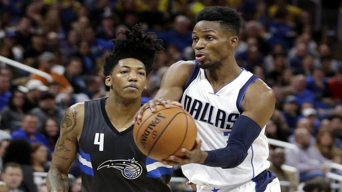 Mavericks point guard Jonathan Gibson, right, passing around the Orlando Magic’s Elfrid Payton, scored 26 points off the bench Saturday in his second NBA game.