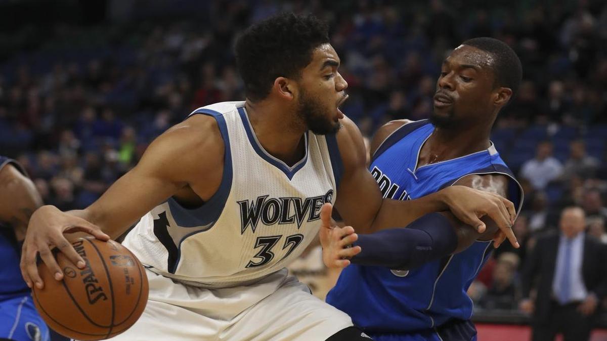 Karl-Anthony Towns, left, was too much to handle for Harrison Barnes and the Mavericks on Monday as the Wolves center finished with 34 points and 11 rebounds.