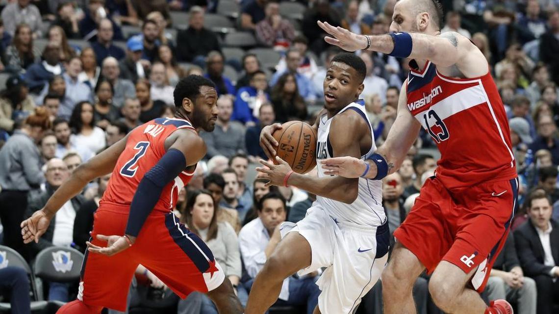 Rookie point guard Dennis Smith Jr., center, scored 17 points Monday to help the Mavericks get past John Wall, left, Marcin Gortat and the Wizards.