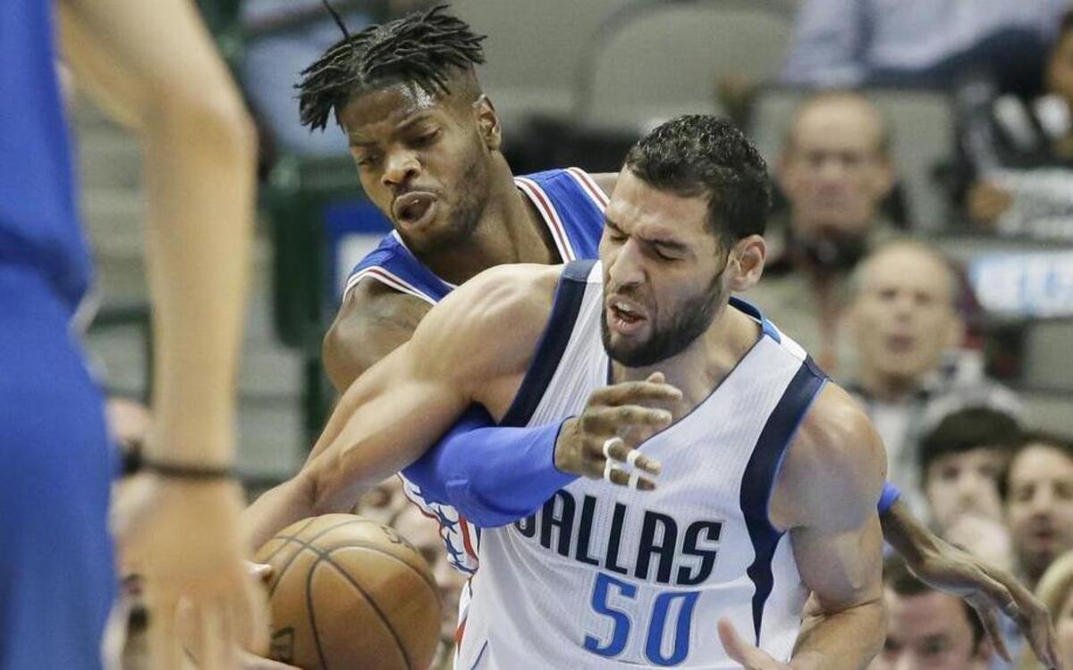 Dallas Mavericks center Salah Mejri, right, and Philadelphia 76ers forward Nerlens Noel (4) vie for control of the ball during the first half Wednesday. Mejri scored a season-high 16 points and grabbed a career-high 17 rebounds.