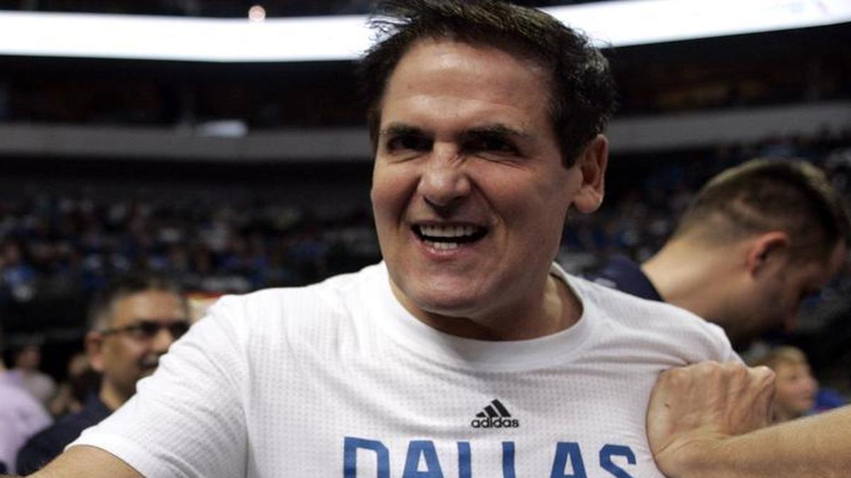 Dallas Mavericks owner Mark Cuban high-fives and socializes with fans before a recent home game. The Mavericks were in Denver in 2000 the day word came down that Cuban has reached an agreement to buy the team.