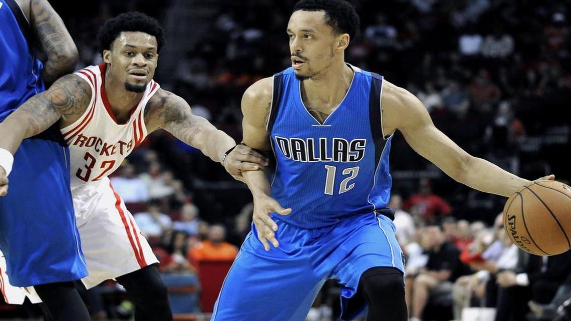 
Guard John Jenkins (12), who led the Mavericks with 19 points, works away from Houston’s K.J. McDaniels.


