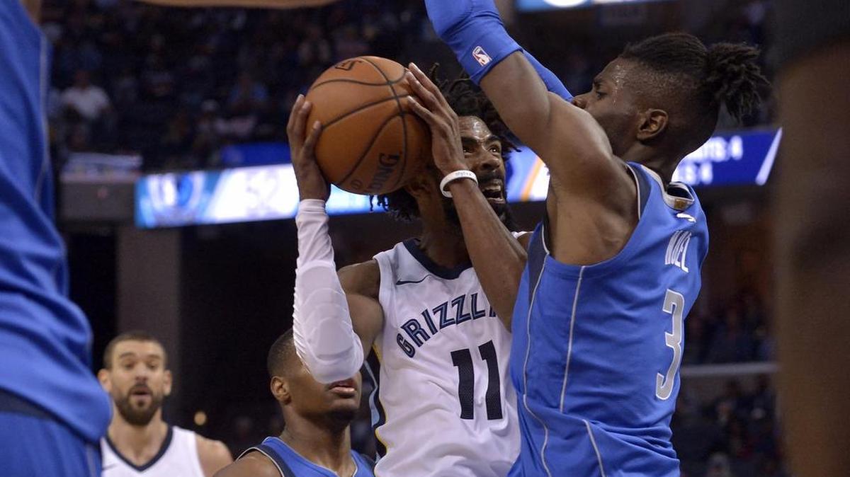 Memphis Grizzlies guard Mike Conley (11) drives against Dallas Mavericks forward Nerlens Noel (3) in the second half Thursday’s game in Memphis, Tenn.