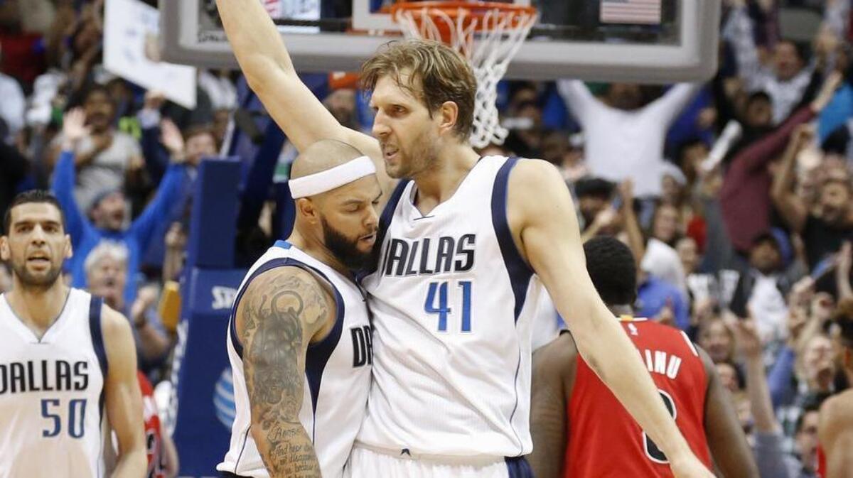Mavericks forward Dirk Nowitzki, right, scored eight straight points in overtime, all on assists by point guard Deron Williams.