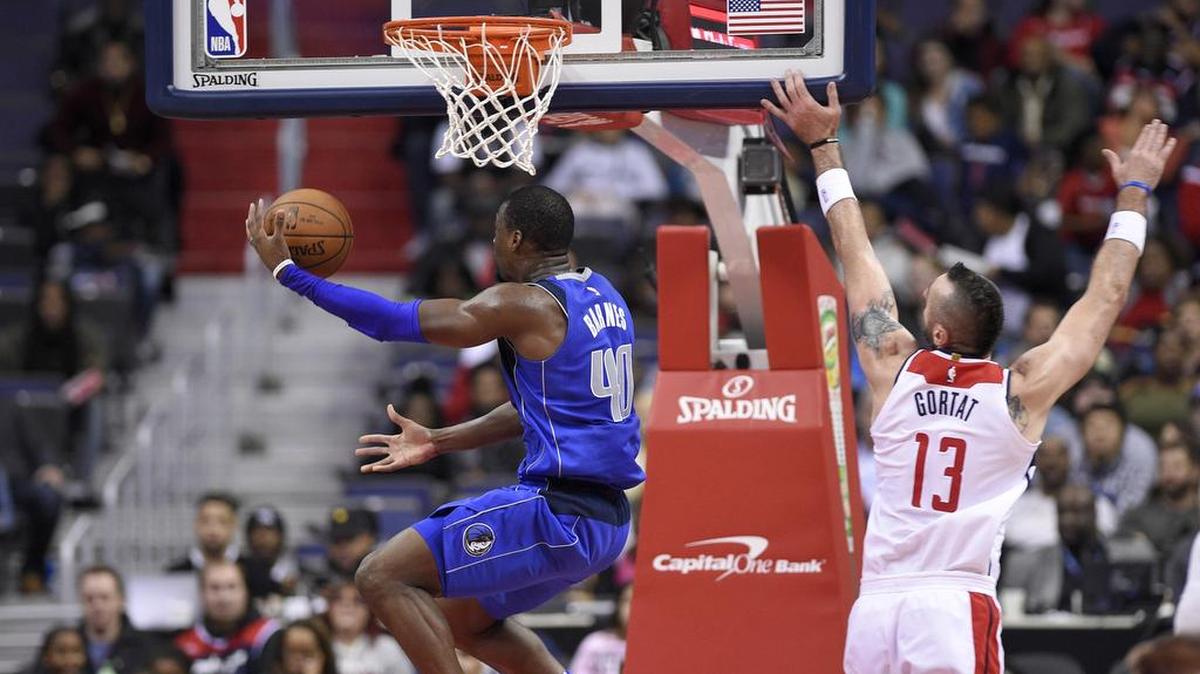 Dallas Mavericks forward Harrison Barnes (40) flies past Washington Wizards center Marcin Gortat for two of his game-high 31 points Tuesday in Washington, D.C. The Mavericks won 113-99.