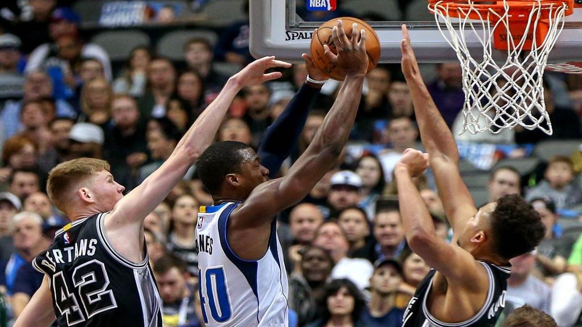 Mavericks forward Harrison Barnes, middle, is again likely to see Spurs players Davis Bertans, left, and Kyle Anderson, right, as San Antonio sits the majority of its starting lineup for Friday’s game.