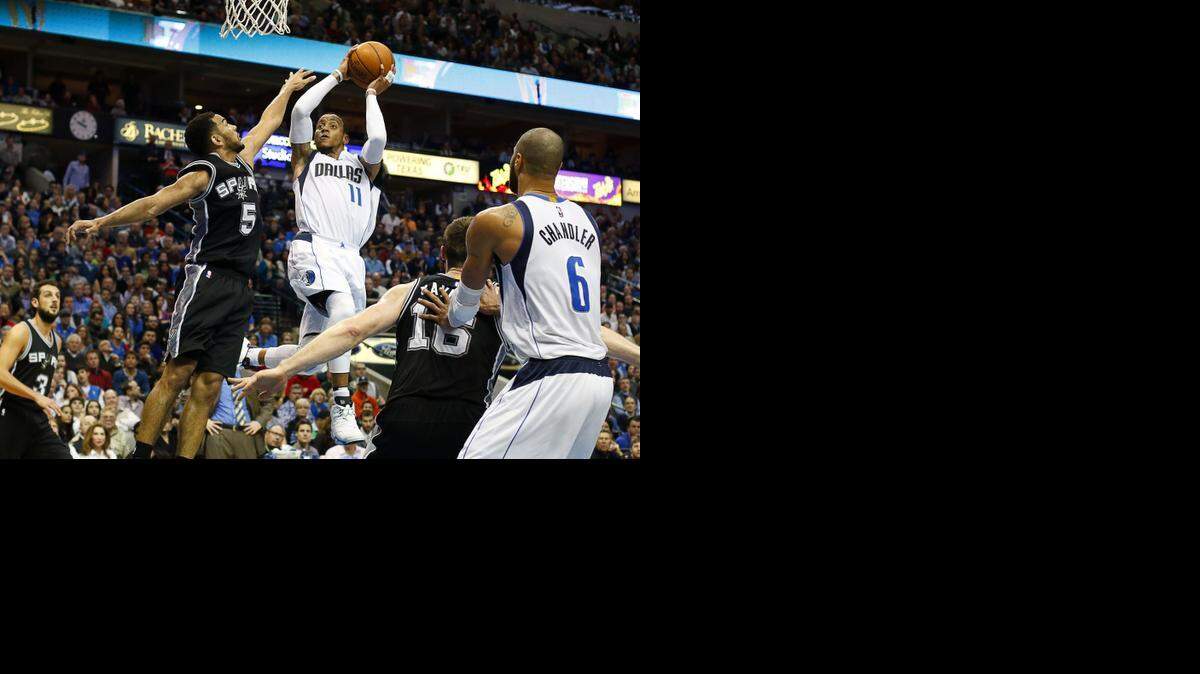 
Dallas Mavericks guard Monta Ellis (11) shoots over San Antonio Spurs guard Cory Joseph (5) during the second half of a NBA basketball game at American Airlines Center in Dallas, TX on Dec. 20, 2014. Dallas Mavericks won 99-93. 
