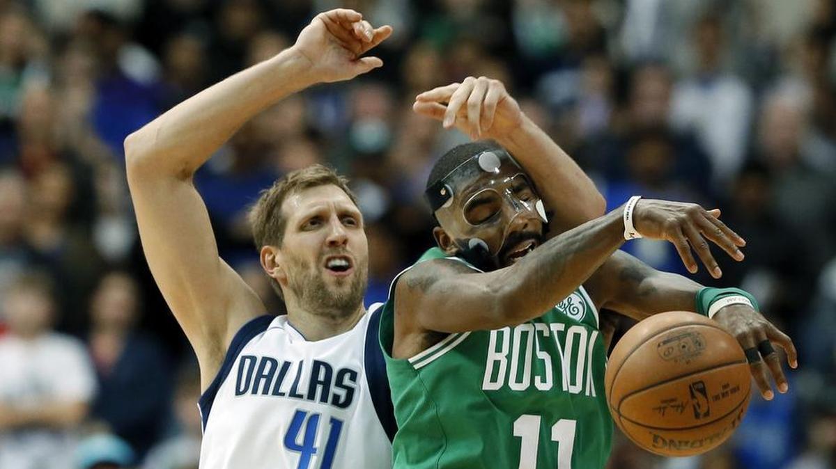 Boston Celtics guard Kyrie Irving (11) intercepts a pass intended for Dallas Mavericks' Dirk Nowitzki (41) of Germany in the second half of an NBA basketball game, Monday, Nov. 20, 2017, in Dallas. The Celtics won in overtime, 110-102.