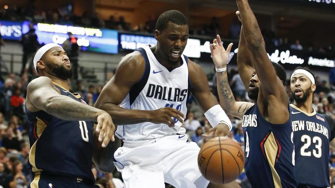 Dallas Mavericks forward Harrison Barnes (40) is stripped of the ball by New Orleans Pelicans center DeMarcus Cousins (0) as guard Tony Allen, second from left, assists and forward Anthony Davis (23) is near Friday night in Dallas.