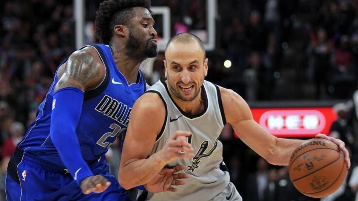 San Antonio Spurs guard Manu Ginobili, right, drives past Mavericks defender Wesley Matthews to score the game-winning basket in the closing seconds of a 98-96 Spurs win in San Antonio.