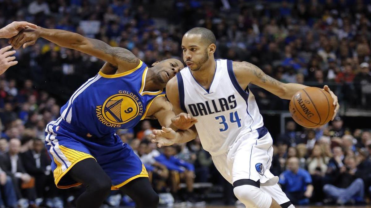 Guard Devin Harris, driving against the Warriors’ Andre Iguodala, is out with a back injury.