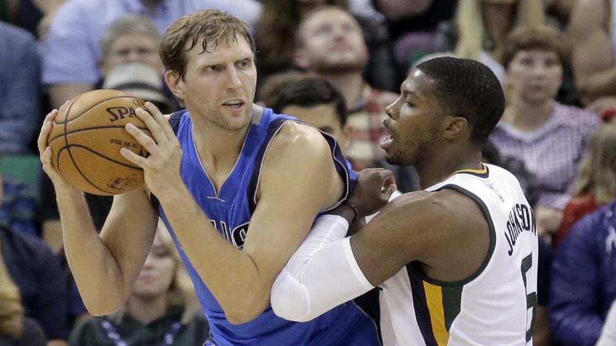 Mavericks forward Dirk Nowitzki, left, guarded by Jazz forward Joe Johnson, finished with nine points Wednesday on 4-of-14 shooting.