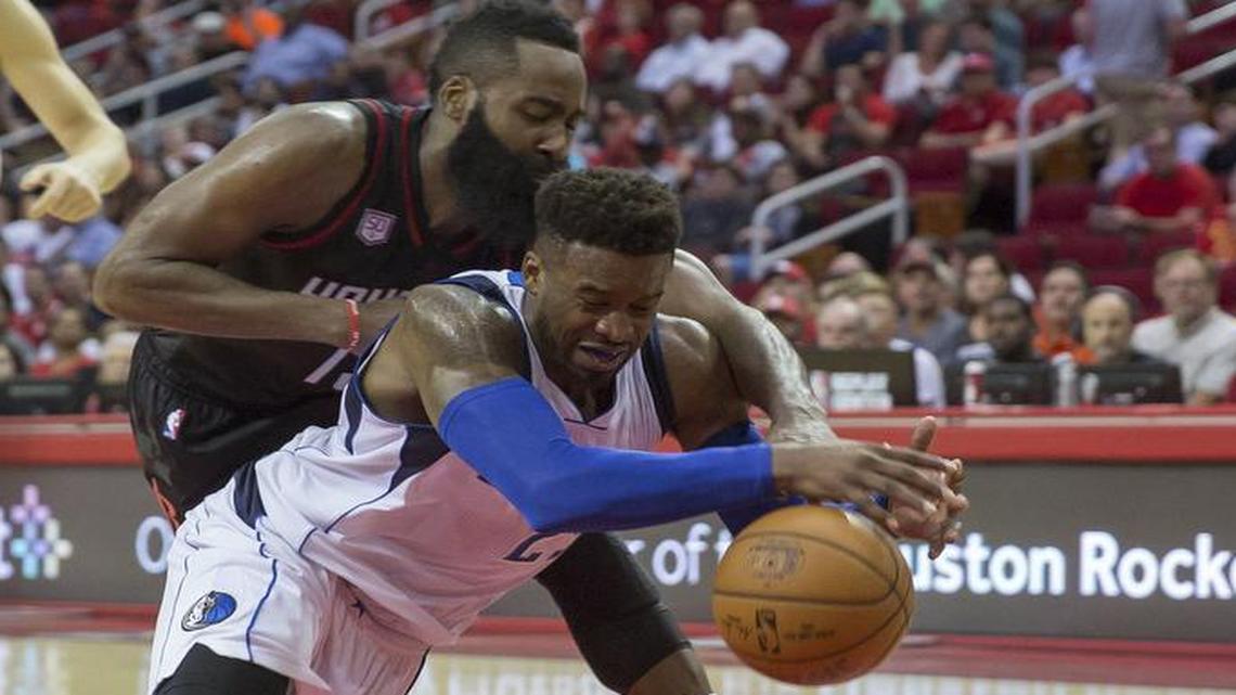 Houston Rockets guard James Harden, left, and Dallas Mavericks forward Wesley Matthews chase down a loose ball in the Oct. 30 game in Houston.