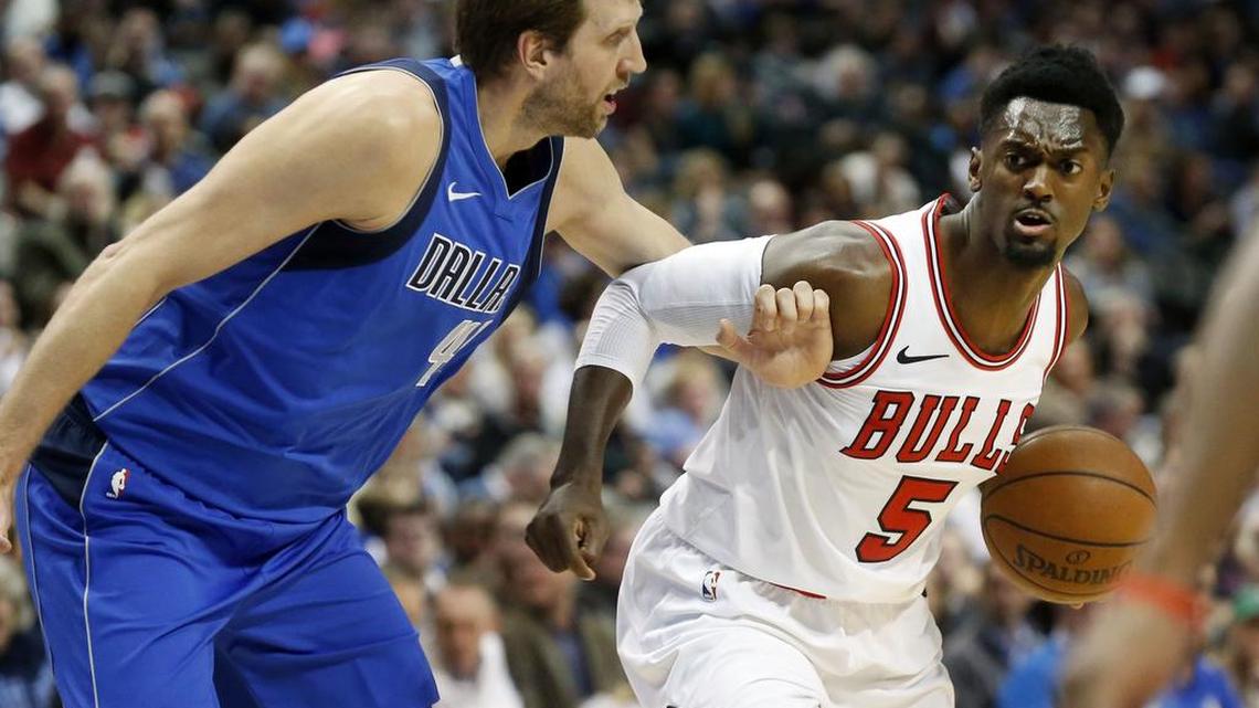 Mavericks forward Dirk Nowitzki, left, defends Chicago Bulls forward Bobby Portis in the first half of Friday’s game in Dallas.