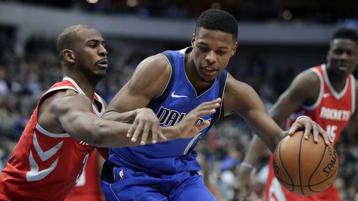 Houston Rockets guard Chris Paul, left, defends as Dallas Mavericks guard Dennis Smith Jr. drives towards the basket in during a game Wednesday night in Dallas.