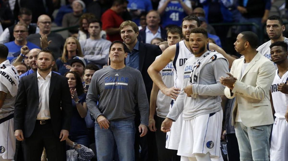 Dallas Mavericks owner Mark Cuban, center, watches with his team on the bench the final seconds of a 91-81 win against the New Orleans Pelicans on Sunday.