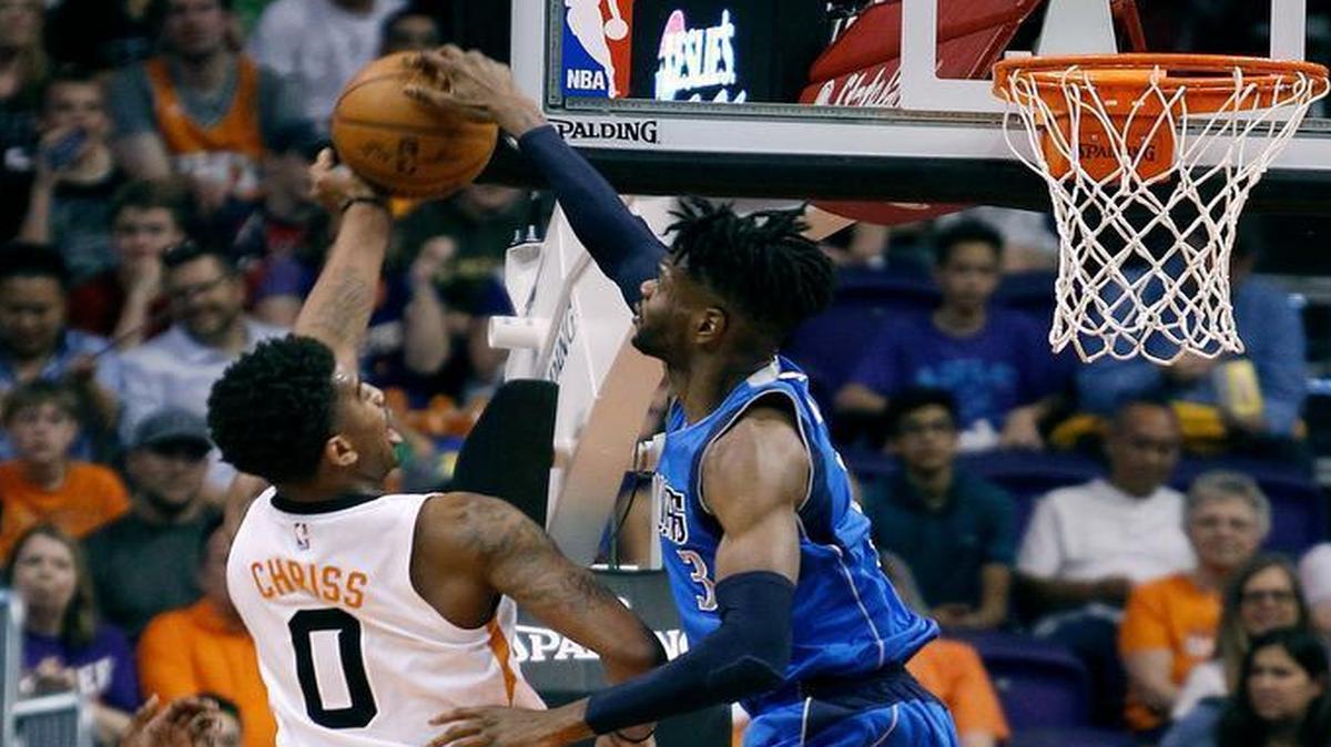 Dallas Mavericks center Nerlens Noel (3) blocks the shot of Phoenix Suns forward Marquese Chriss during the first half of an NBA basketball game, Sunday, April 9, 2017, in Phoenix.
