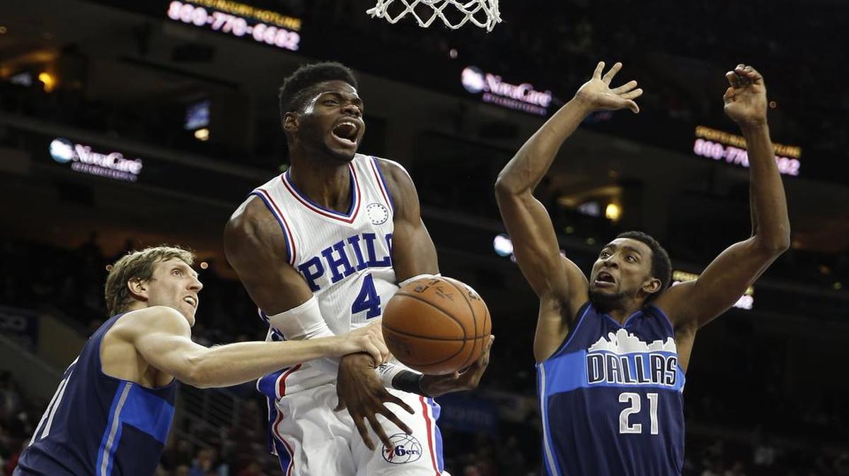 Dirk Nowitzki, left, and Jeremy Evans of the Mavericks forced 27 turnovers Monday night against Nerlens Noel and the Sixers.