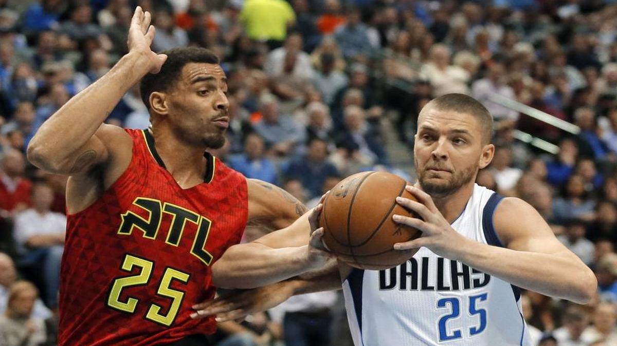 Atlanta Hawks guard Thabo Sefolosha, left, defends as Dallas Mavericks forward Chandler Parsons moves to the basket in the first half Wednesday in Dallas. Parsons has been coming off the bench as a sixth man as he works back from off-season knee surgery.