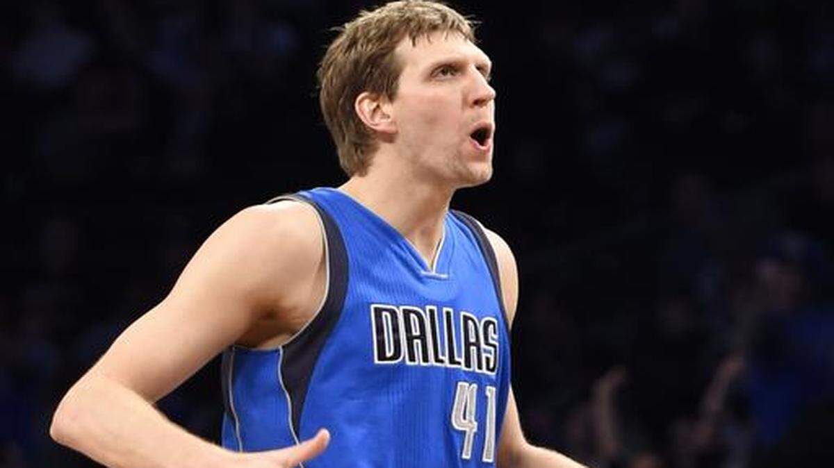 
Dallas Mavericks forward Dirk Nowitzki gestures after scoring a 3-point basket against the Brooklyn Nets in overtime.
