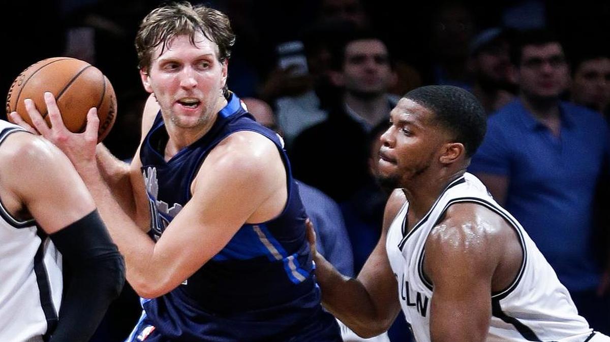 Dallas Mavericks’ Dirk Nowitzki, seond from right, is defended by Brooklyn Nets’ Joe Johnson (7) during the overtime period of an NBA basketball game Wednesday, Dec. 23, 2015, in New York. The Mavericks won 119-118.