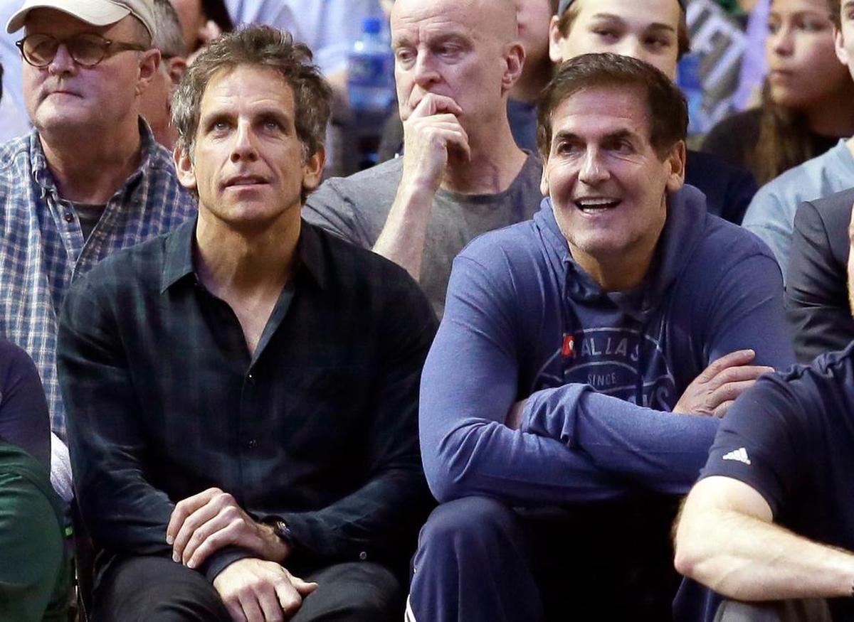 Dallas Mavericks owner Marc Cuban, right, and actor Ben Stiller watch the first half of an NBA basketball game between Mavericks and Orlando Magic in Dallas, Saturday, Feb. 11, 2017.