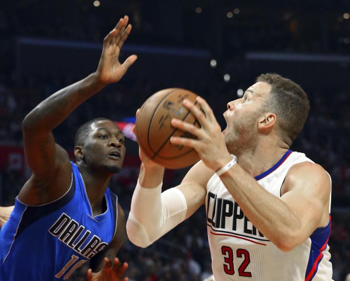Los Angeles Clippers forward Blake Griffin, right, tries a pump fake on Dallas Mavericks forward Dorian Finney-Smith during the first half of an NBA basketball game in Los Angeles on Wednesday, April 4, 2017.
