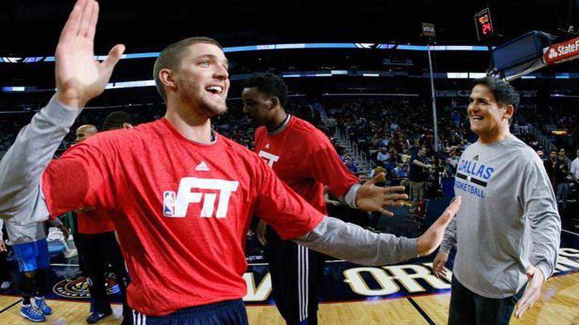 
 Dallas Mavericks owner Mark Cuban is high-fived by forward Chandler Parsons. Cuban wants to see fixes made to an NBA schedule that has too many games being played in clusters. 
