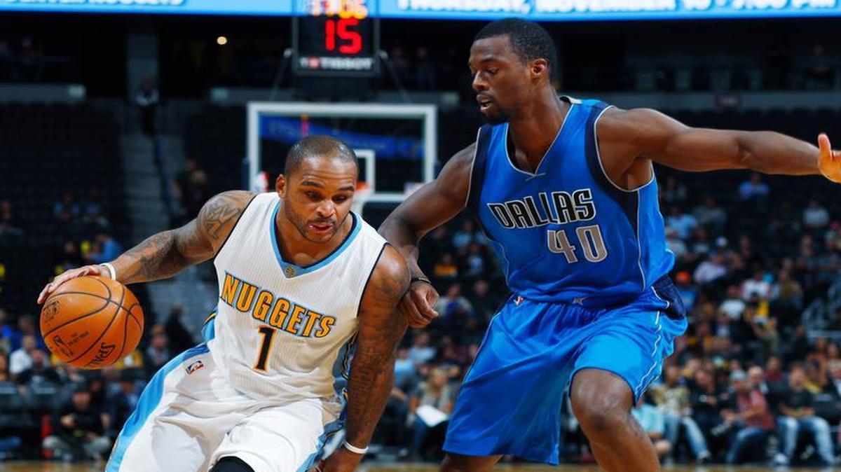 Denver Nuggets guard Jameer Nelson, left, drives as Dallas Mavericks forward Harrison Barnes defends during the second half of an NBA preseason basketball game Friday, Oct. 21, 2016, in Denver.
