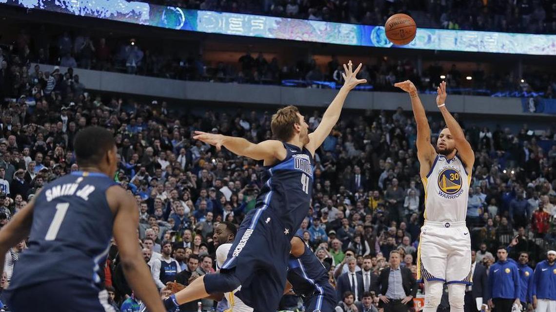With the game tied and 3 seconds on the clock, Golden State Warriors guard Stephen Curry (30) sinks the winning 3-point shot over Dallas Mavericks forward Dirk Nowitzki (41) as the Golden State Warriors beat the Dallas Mavericks 125-122 in Dallas on Wednesday.