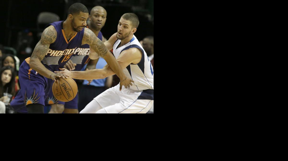
Phoenix Suns forward Marcus Morris (15) drives against Dallas Mavericks forward Chandler Parsons during the second half. 
