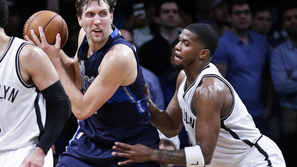Dallas Mavericks' Dirk Nowitzki, seond from right, is defended by Brooklyn Nets' Joe Johnson (7) during the overtime period of an NBA basketball game Wednesday, Dec. 23, 2015, in New York. The Mavericks won 119-118.