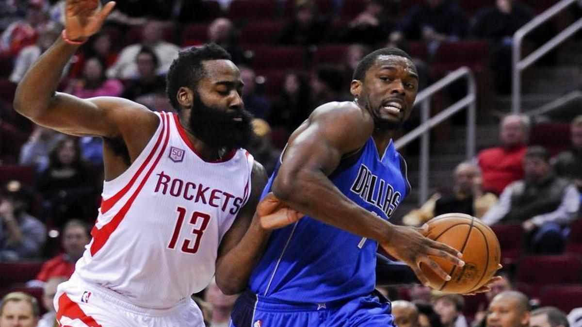 Mavericks forward Harrison Barnes, right, drives around Rockets guard James Harden on Saturday.