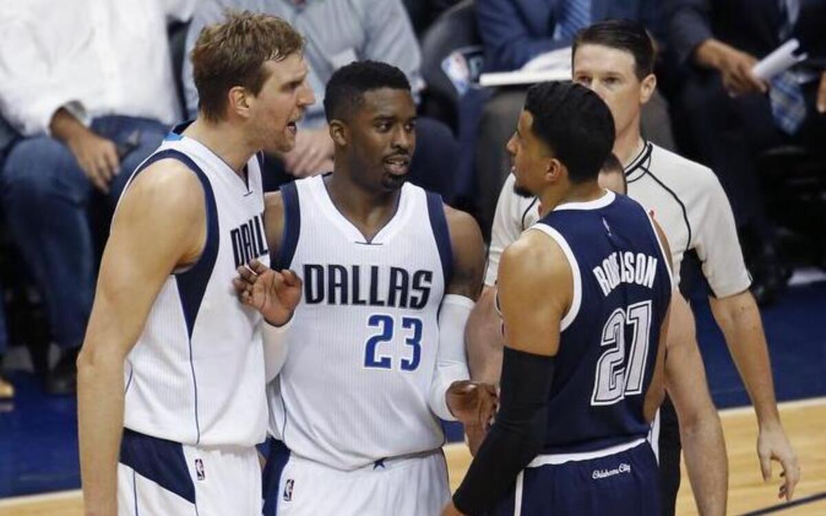 Dallas Mavericks guard Wesley Matthews keeps teammate forward Dirk Nowitzki and Oklahoma City Thunder guard Andre Roberson apart after Roberson fouled Nowitzki in the third period.