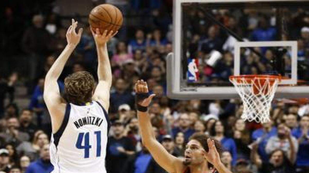 
Dallas Mavericks forward Dirk Nowitzki (41) shoots a 3pointer over Portland Trail Blazers guard Wesley Matthews (2) and center Robin Lopez (42) to tie the score, helping send the  game into overtime, Saturday, February 7, 2015, at the American Airlines Center, Dallas,Texas. The Mavericks won 111-101. 
